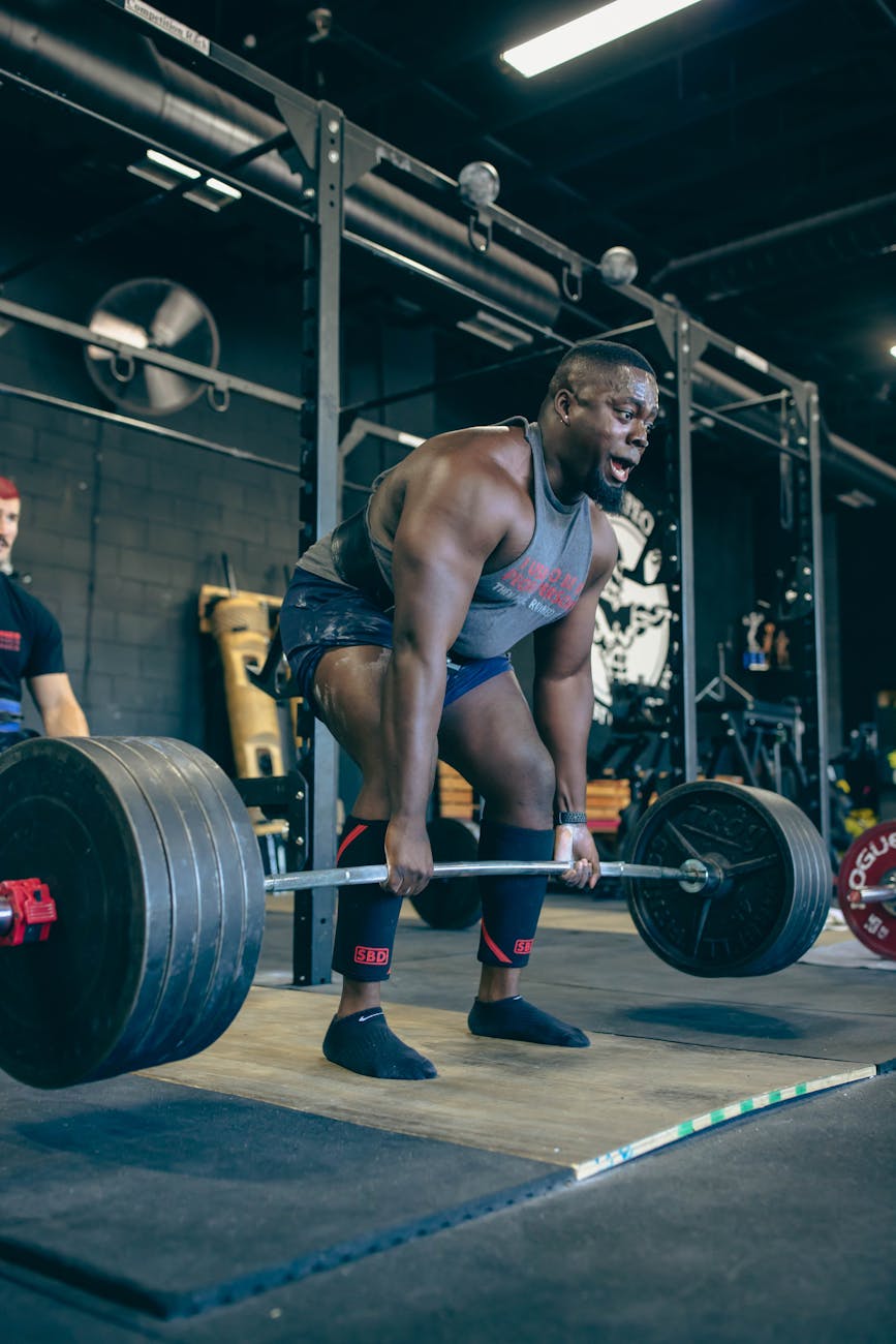 strong muscular man weightlifting in gym
