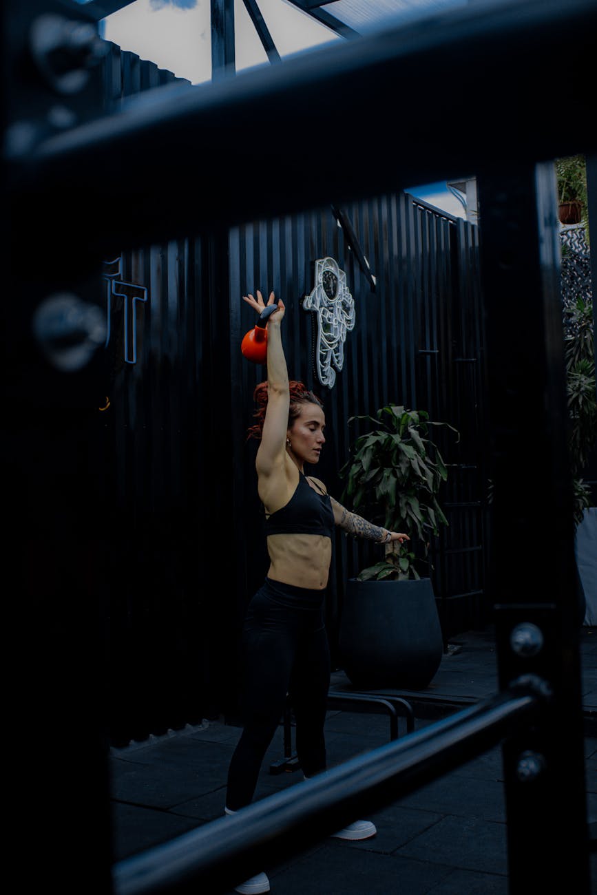 woman in black tank top and black pants doing exercise