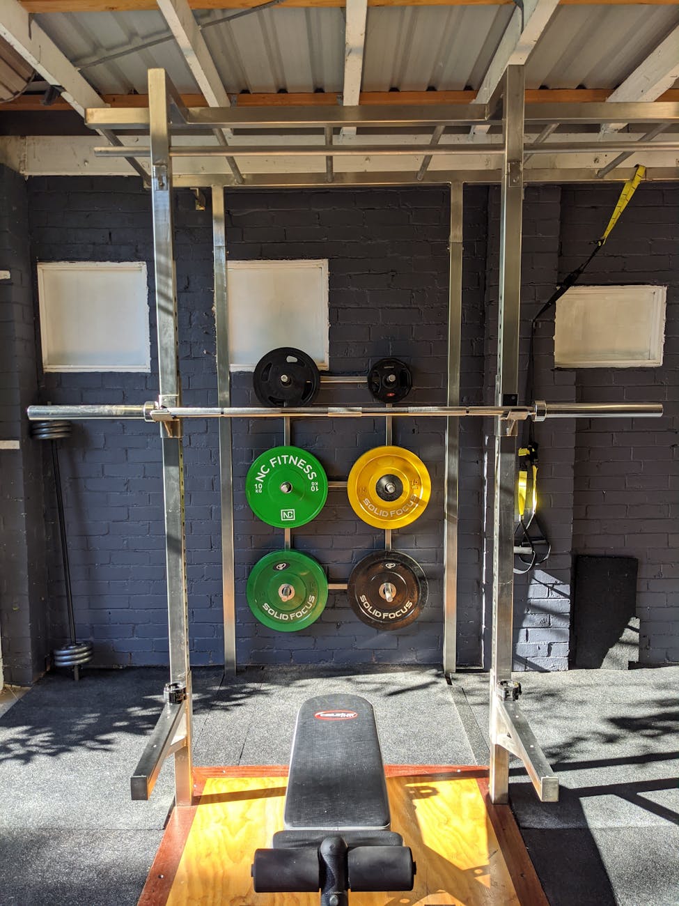 a squat rack at a home gym