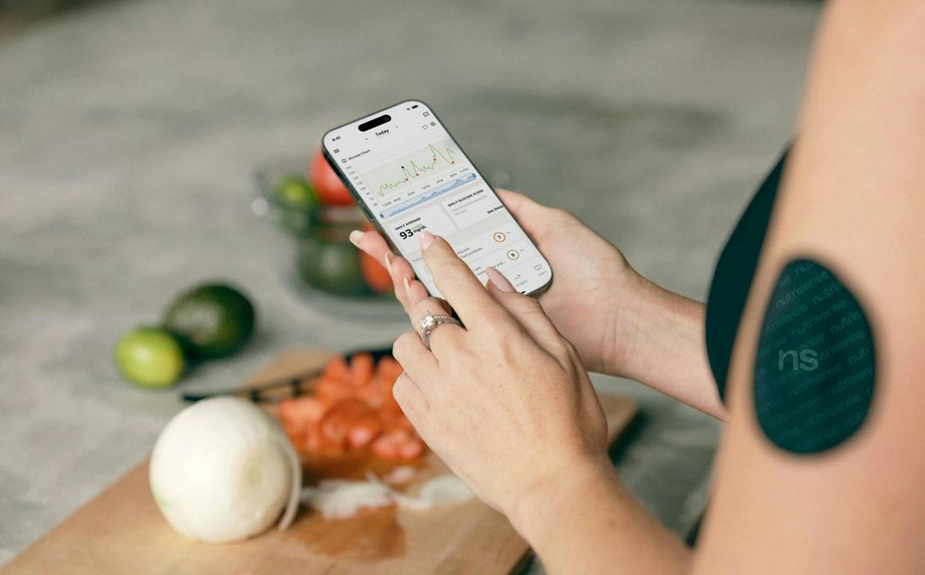 woman measuring blood sugar level with a smart phone app
