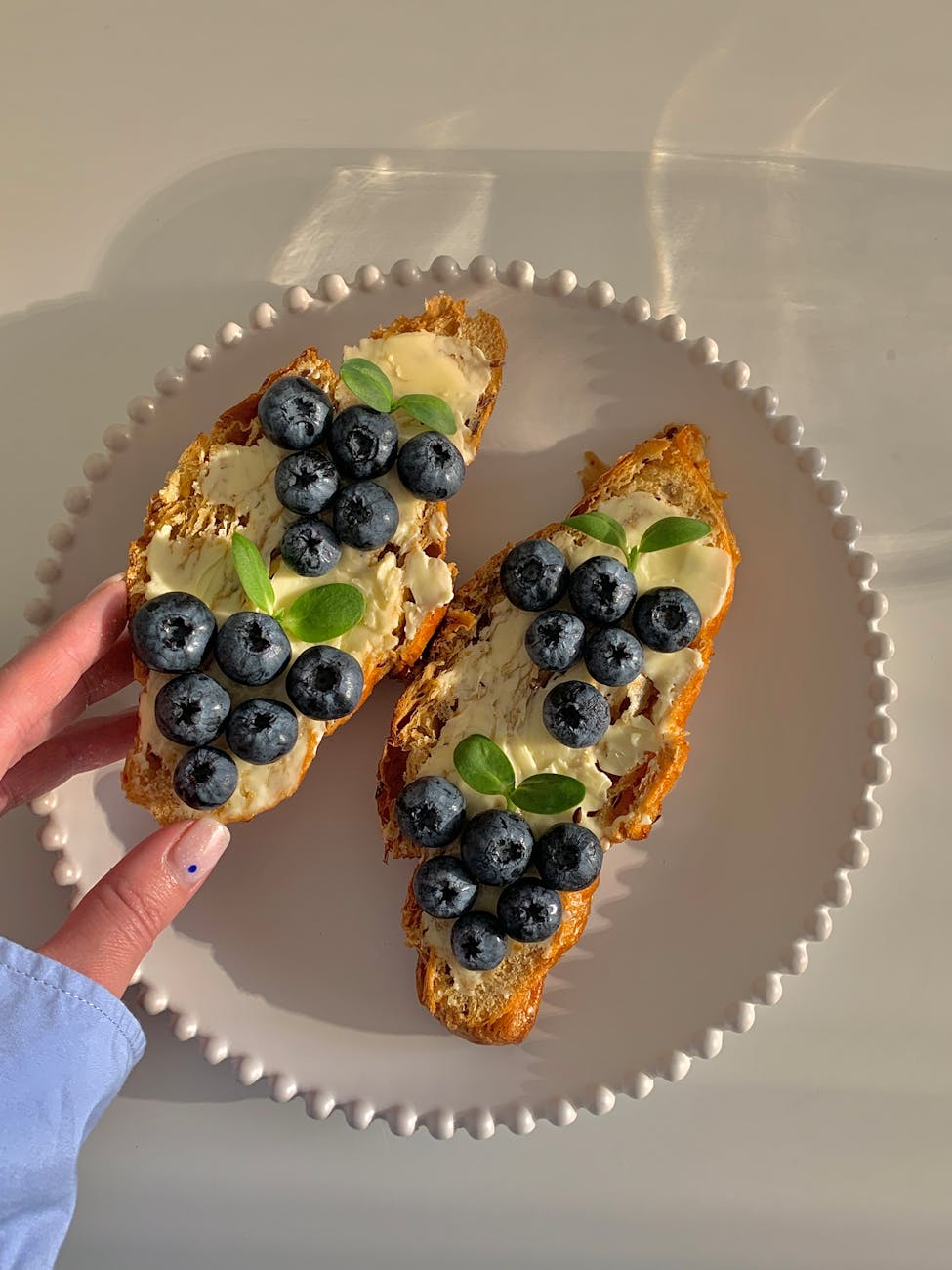 eating slices of bread with blueberries