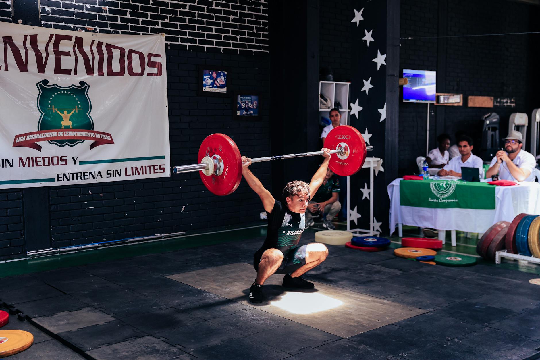 weightlifting competition athlete performing snatch