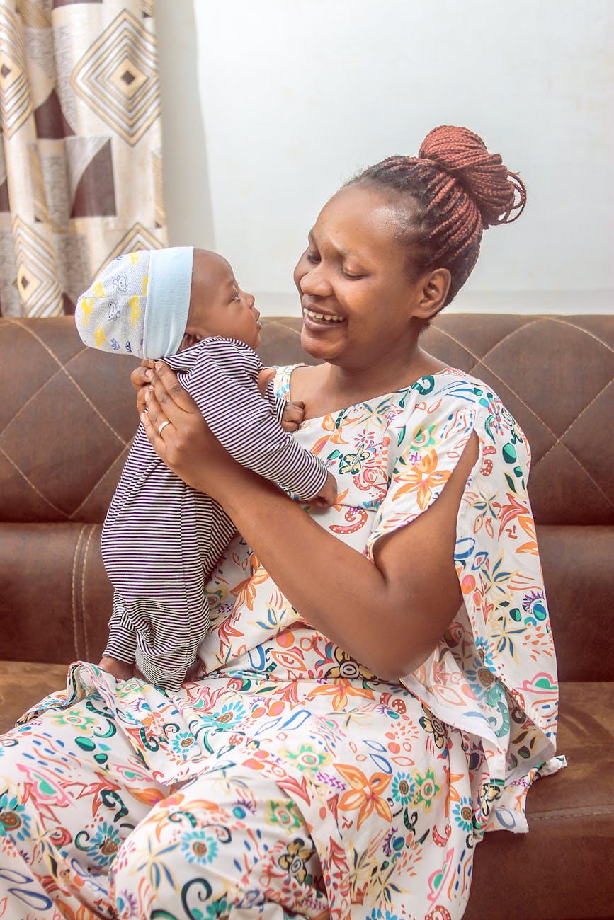 mother joyfully holding her baby indoors