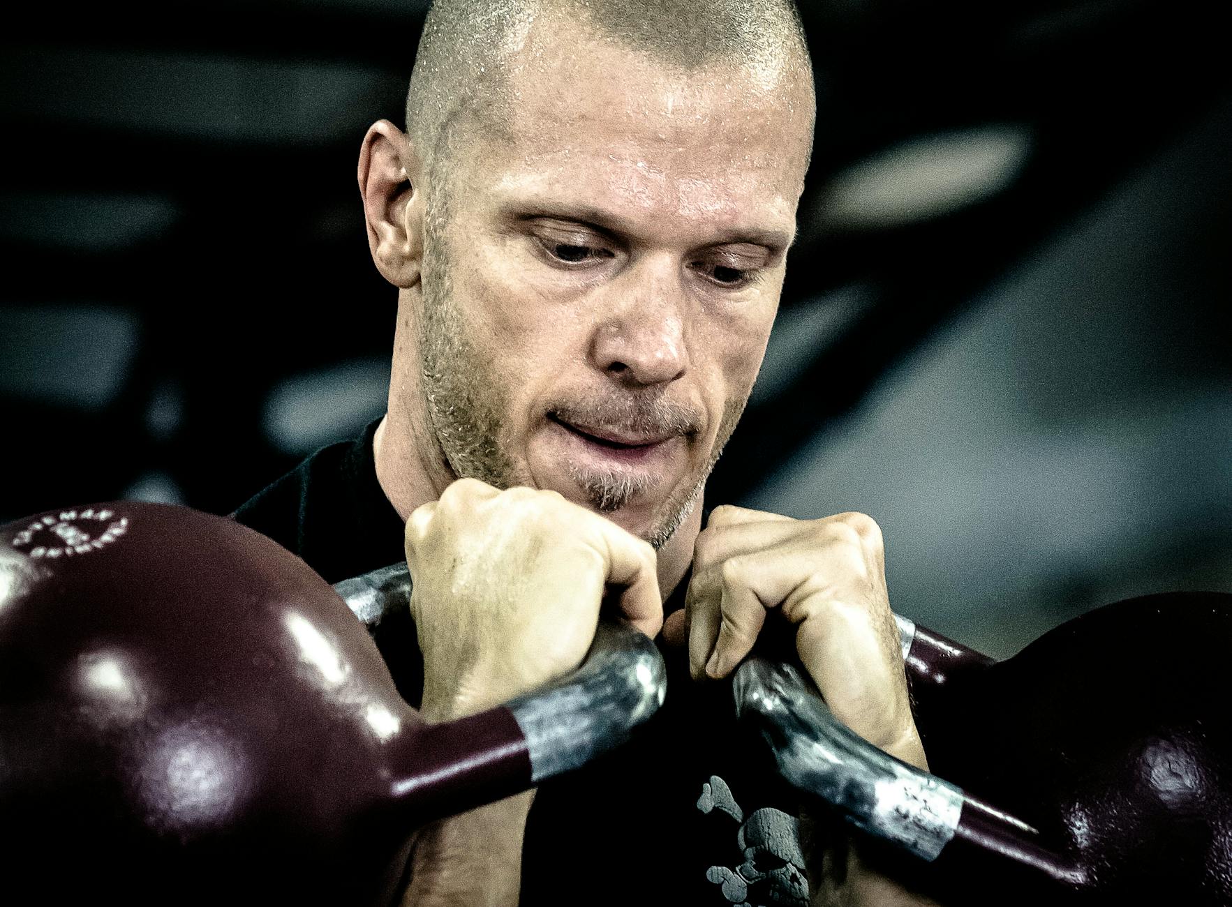 man holding kettle bells