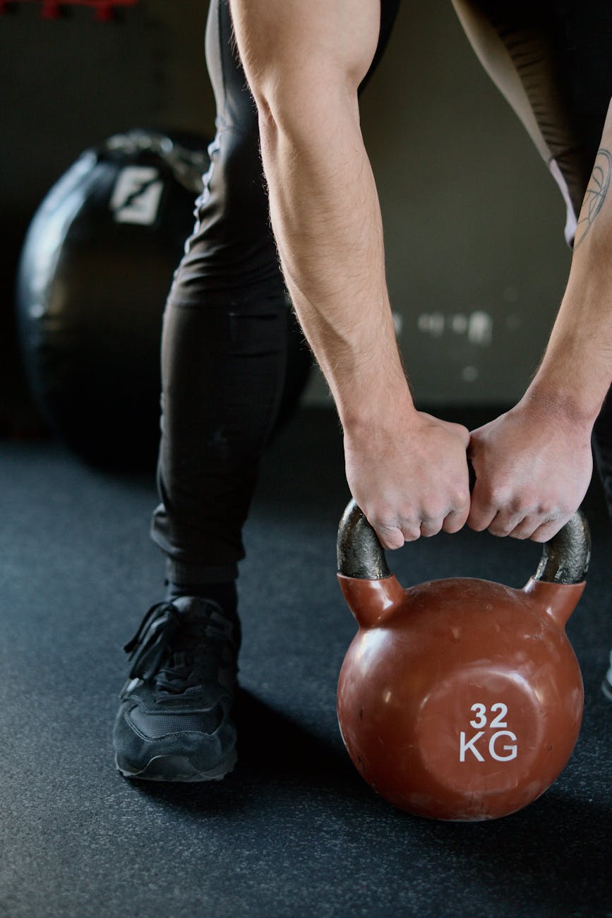 person holding red kettlebell