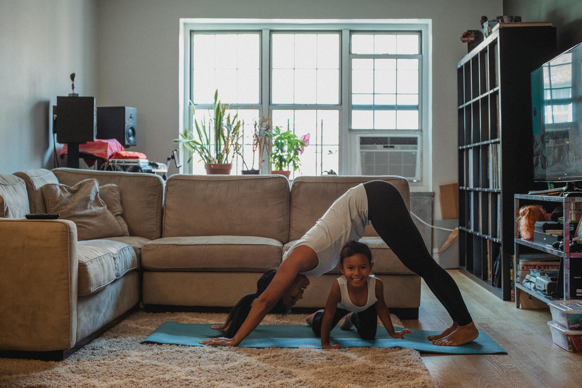 woman doing the downward facing dog pose in the living room