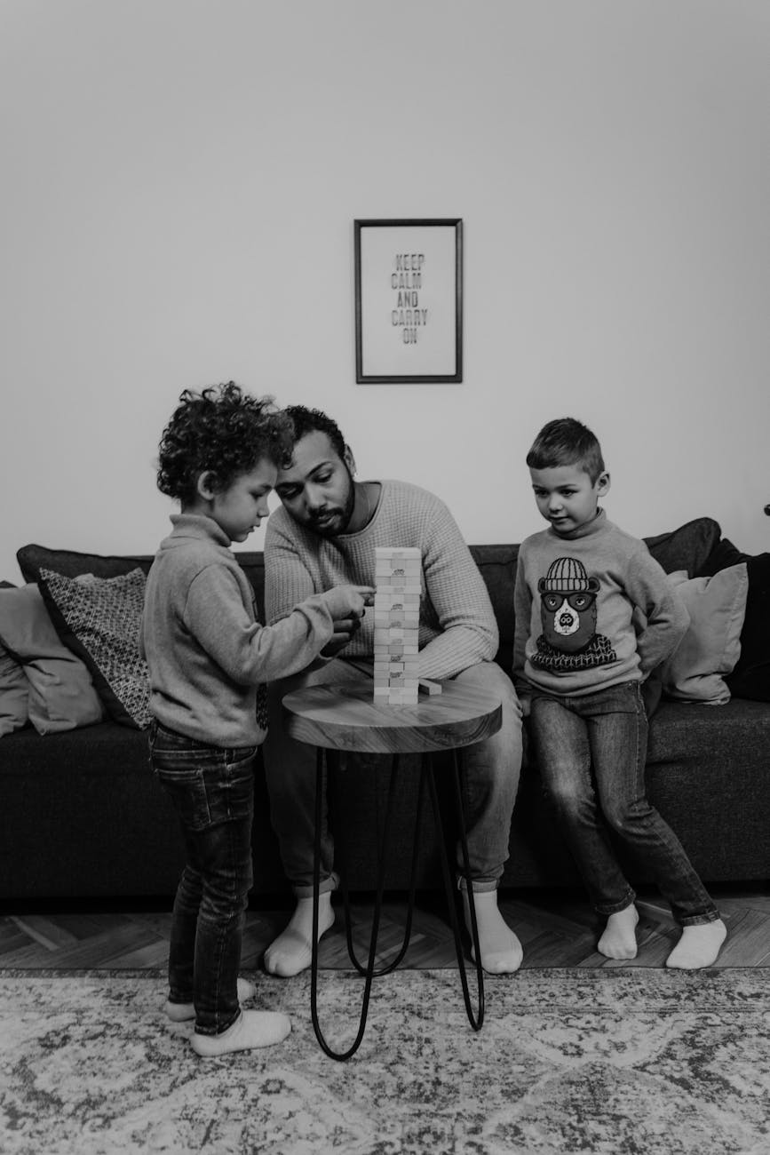 father and sons playing with wood blocks game