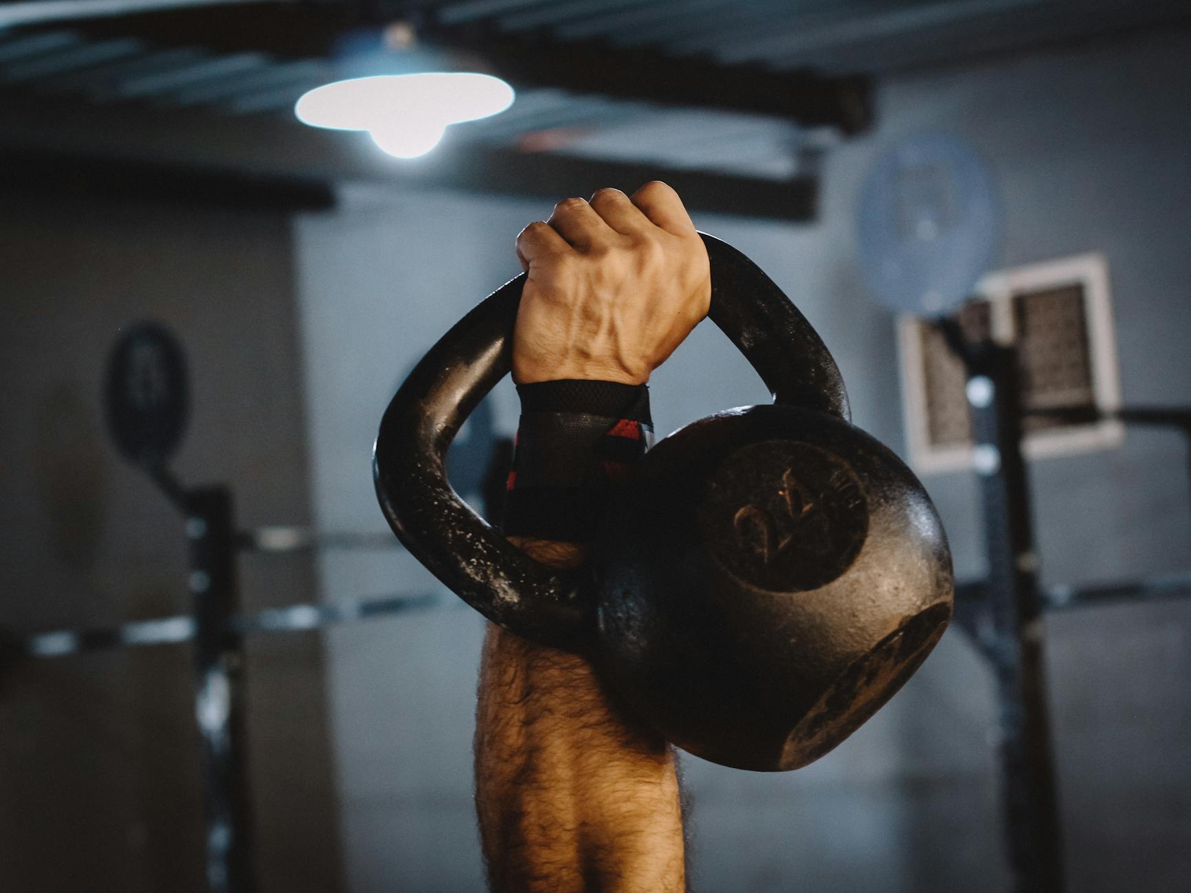 a person lifting a kettlebell