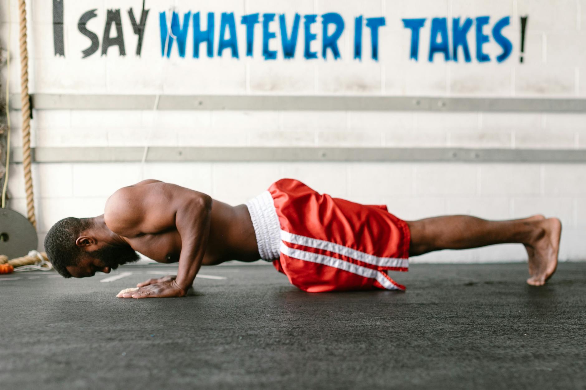 man in a gym doing push ups