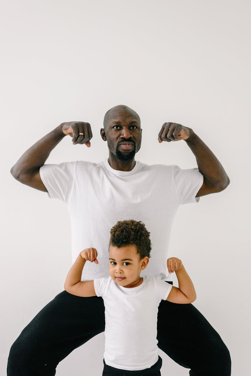 a father and son showing muscle together