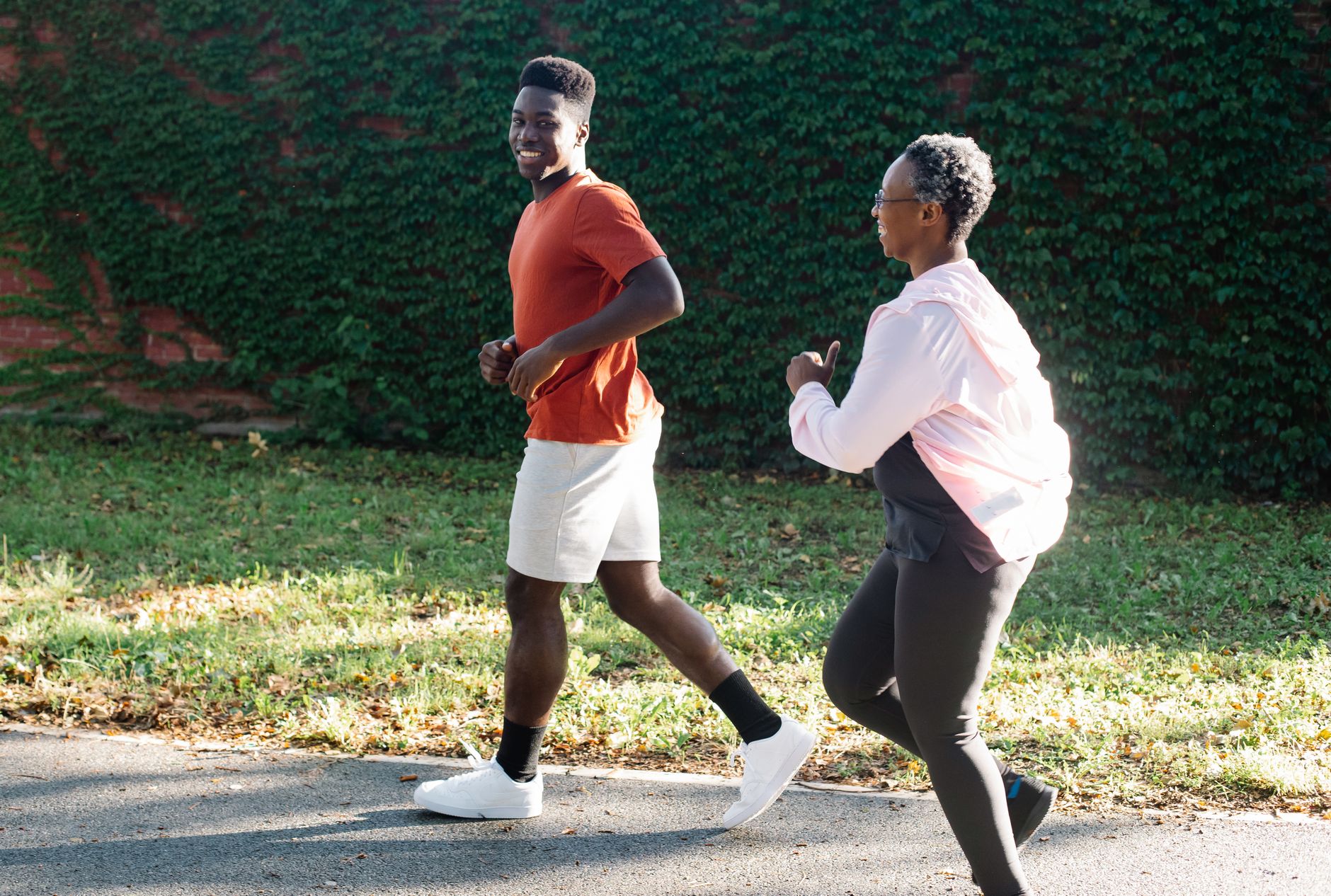 man and woman jogging outdoors